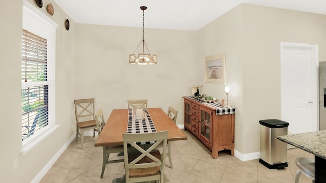 dining space with baseboards, a chandelier, and light tile patterned flooring