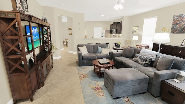 living area with recessed lighting, baseboards, and light tile patterned flooring