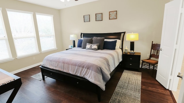 bedroom with baseboards and wood finished floors