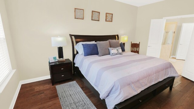 bedroom featuring dark wood-style floors and baseboards