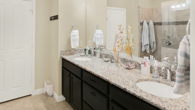 full bath featuring tile patterned floors, double vanity, a sink, and a walk in shower