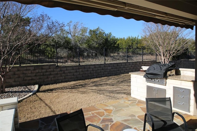 view of patio featuring area for grilling, grilling area, and fence