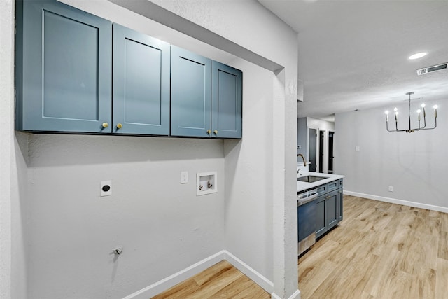 laundry room featuring sink, hookup for an electric dryer, light hardwood / wood-style flooring, and hookup for a washing machine