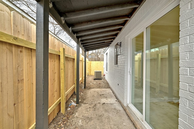 view of side of home with central AC unit