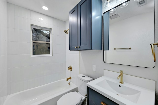 full bathroom featuring toilet, tiled shower / bath, and vanity