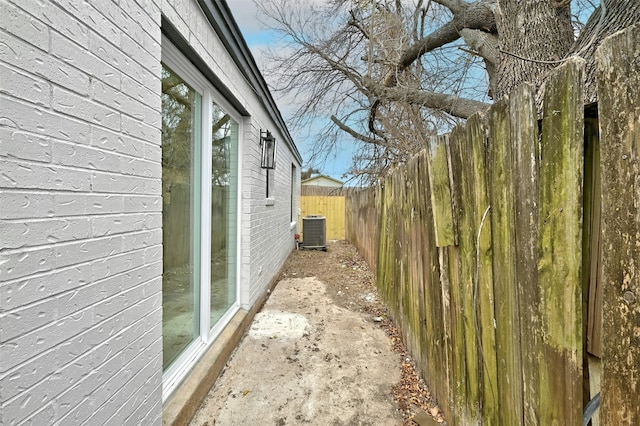 view of side of property with central air condition unit