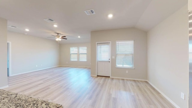 unfurnished room featuring light hardwood / wood-style floors, lofted ceiling, and ceiling fan