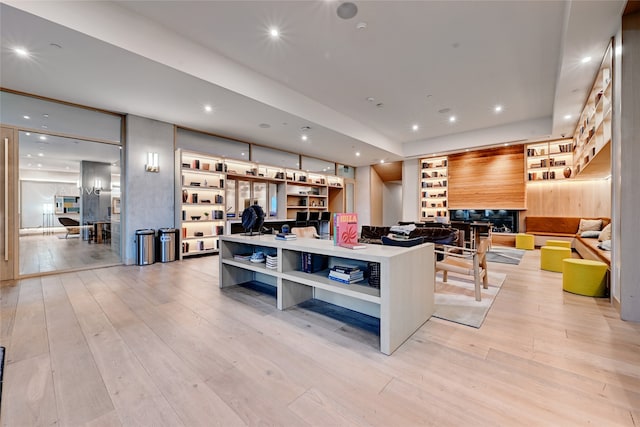 kitchen with a fireplace, light hardwood / wood-style flooring, and a center island