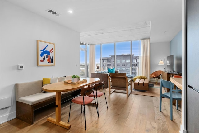 dining room featuring light wood-type flooring and expansive windows