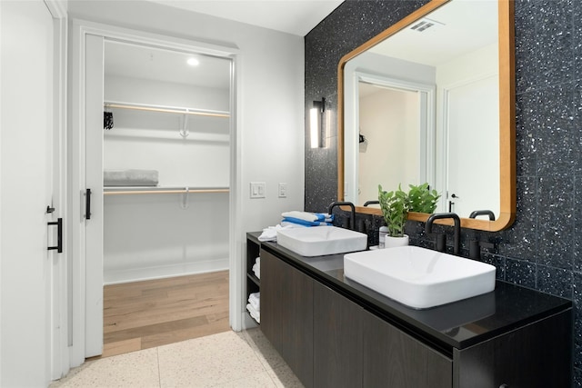 bathroom with vanity and tasteful backsplash