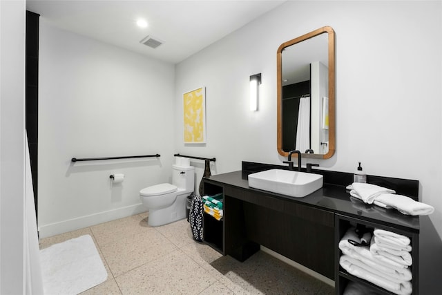 bathroom with toilet and vanity