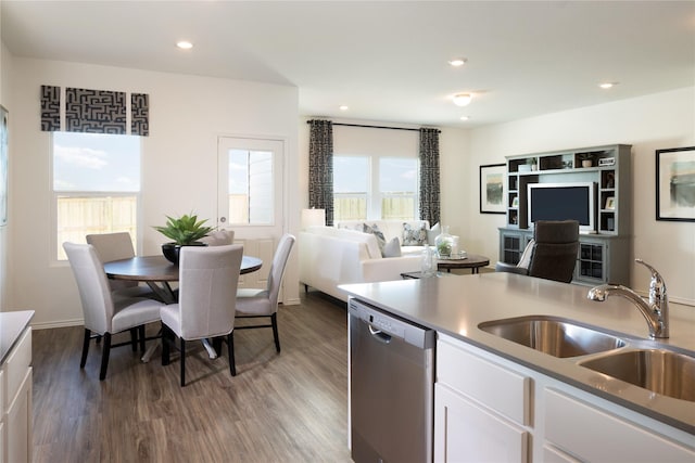 kitchen featuring sink, white cabinetry, stainless steel dishwasher, and a wealth of natural light