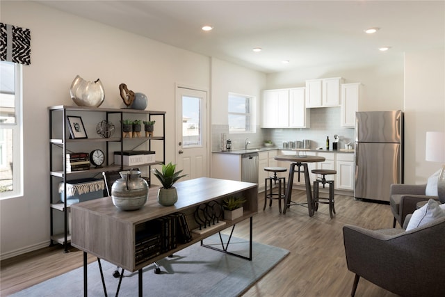 dining space featuring sink and light hardwood / wood-style flooring