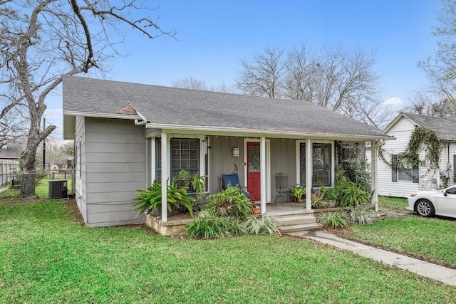 view of front facade with covered porch, cooling unit, and a front yard