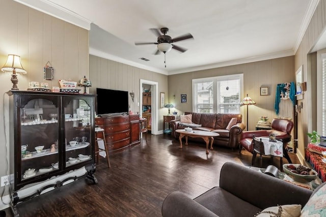 living room featuring ceiling fan, ornamental molding, and dark wood-type flooring