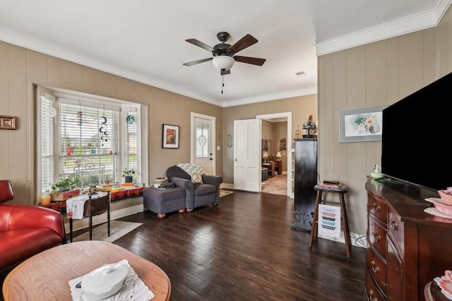 living room with ceiling fan, crown molding, and dark wood-type flooring