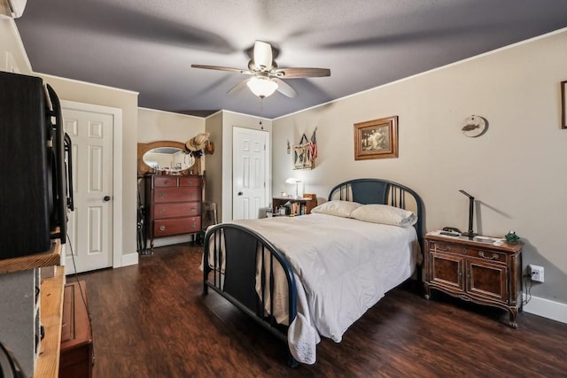 bedroom featuring ceiling fan, crown molding, and dark wood-type flooring