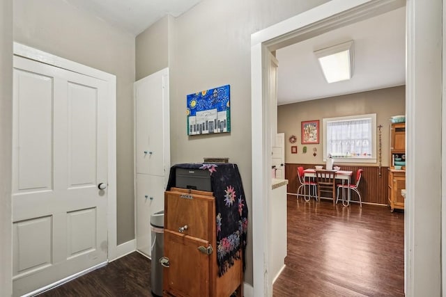 corridor with dark hardwood / wood-style flooring