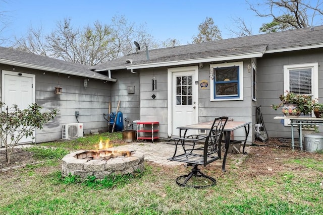 back of house featuring a patio, ac unit, and a fire pit