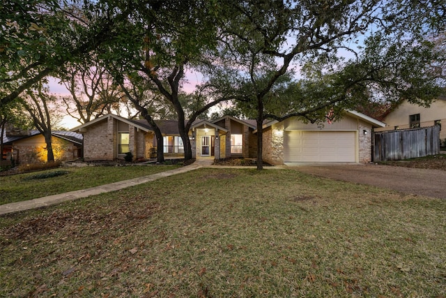 single story home with a garage and a yard