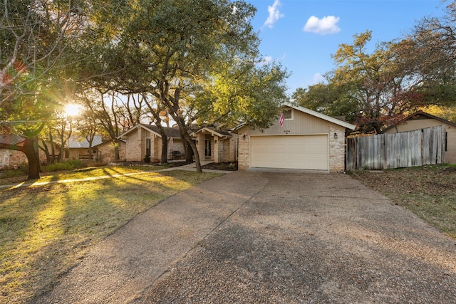 view of front of property with a garage and a front lawn