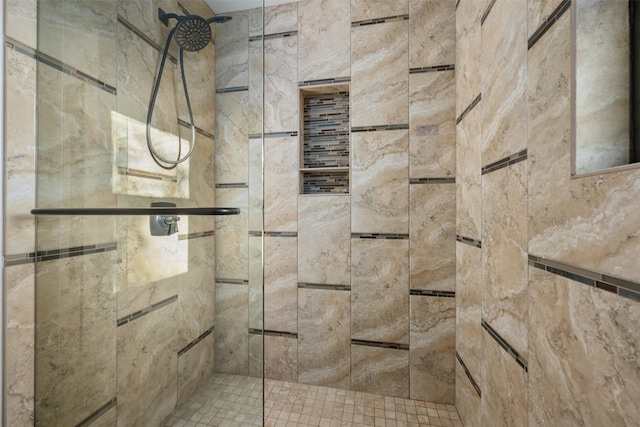 interior details featuring tiled shower