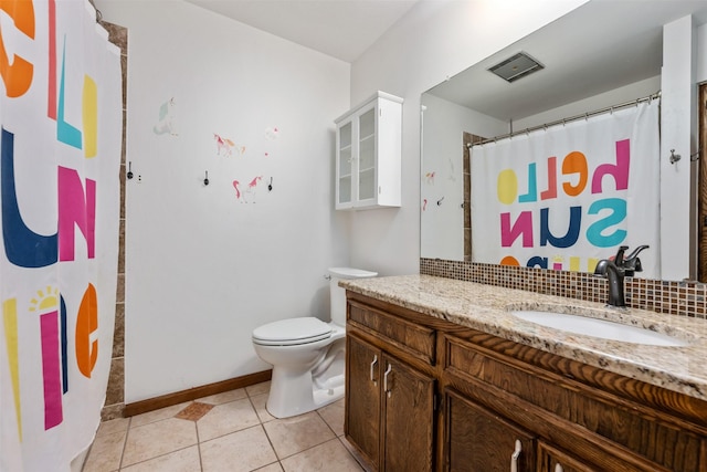 bathroom with vanity, toilet, and tile patterned flooring