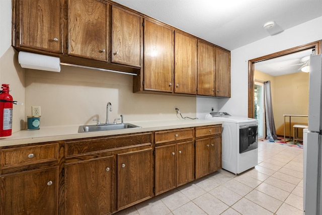 kitchen with washer / dryer, white refrigerator, sink, ceiling fan, and light tile patterned floors