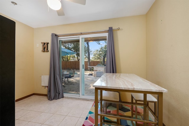 dining space with light tile patterned floors and ceiling fan