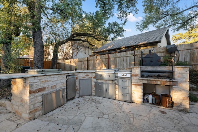 view of patio / terrace with grilling area and exterior kitchen