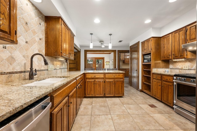 kitchen featuring appliances with stainless steel finishes, decorative backsplash, sink, kitchen peninsula, and light tile patterned floors