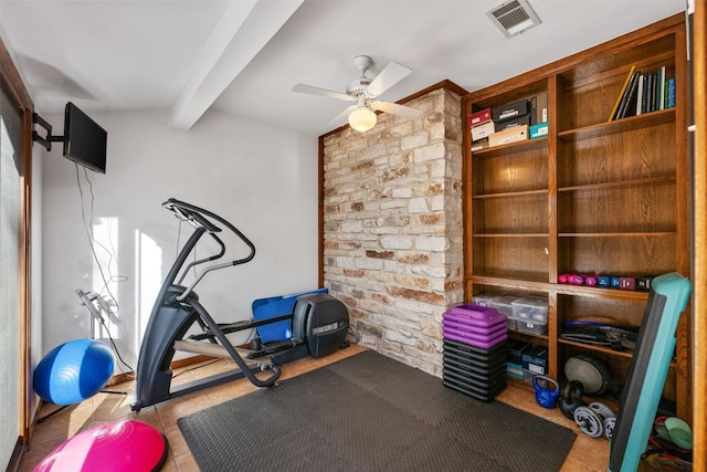 exercise area featuring light tile patterned flooring and ceiling fan