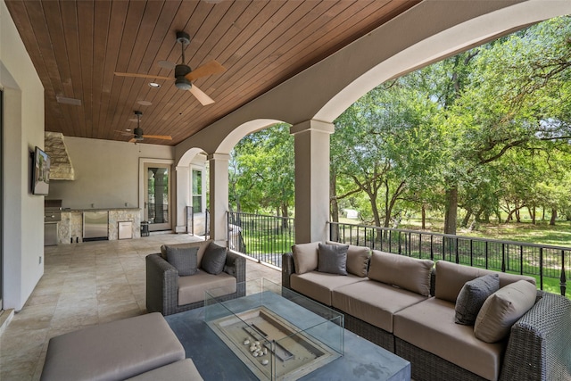 view of patio with an outdoor kitchen, outdoor lounge area, and ceiling fan