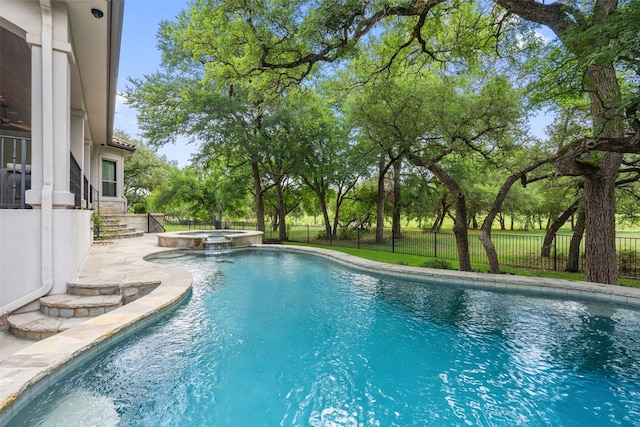 view of pool with an in ground hot tub