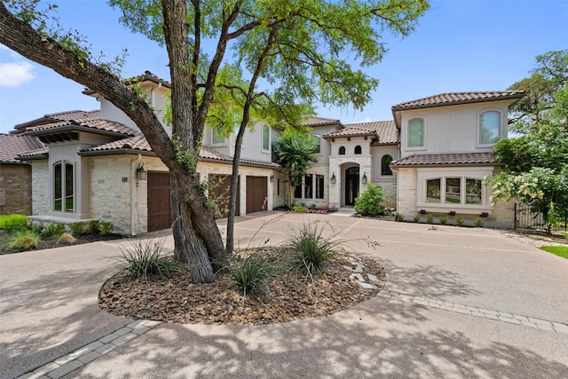 mediterranean / spanish house with a garage