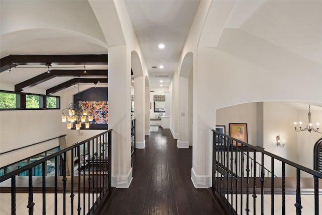 hall featuring hardwood / wood-style floors, vaulted ceiling with beams, and a notable chandelier