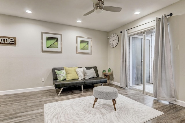 living area featuring ceiling fan and light wood-type flooring