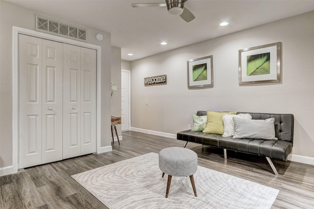 sitting room with wood finished floors, visible vents, baseboards, recessed lighting, and ceiling fan