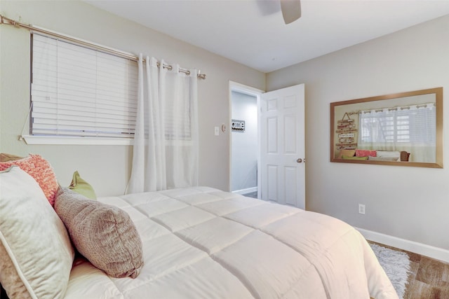 bedroom with ceiling fan and baseboards