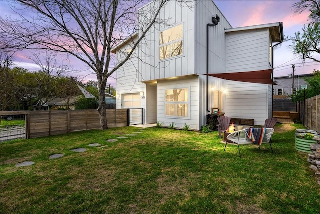 back house at dusk with a yard