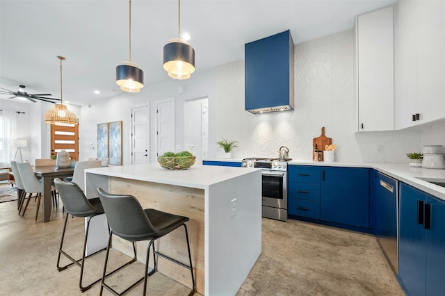 kitchen featuring stainless steel gas stove, hanging light fixtures, white cabinetry, blue cabinets, and a center island