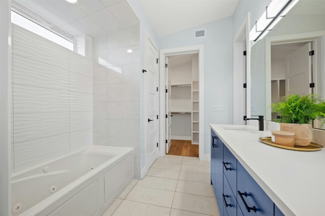 bathroom with vanity, tile patterned floors, and lofted ceiling