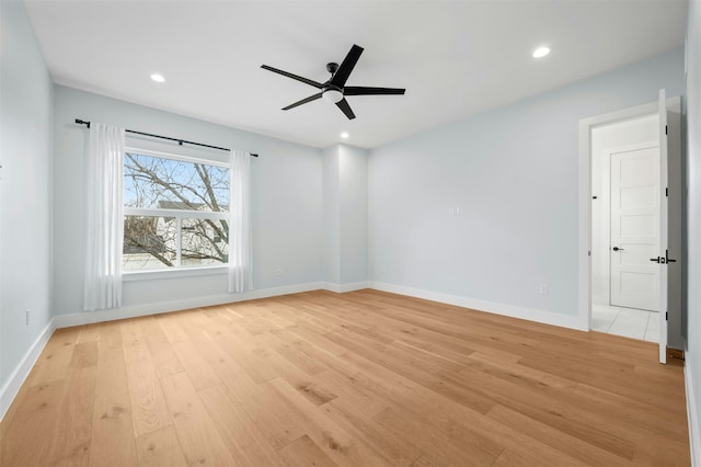 unfurnished room with ceiling fan and light wood-type flooring