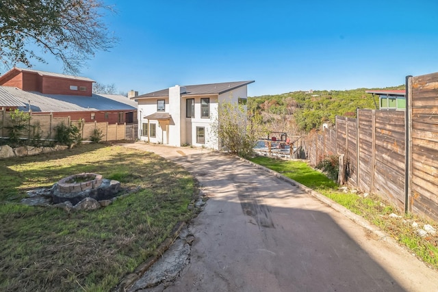 rear view of house with an outdoor fire pit