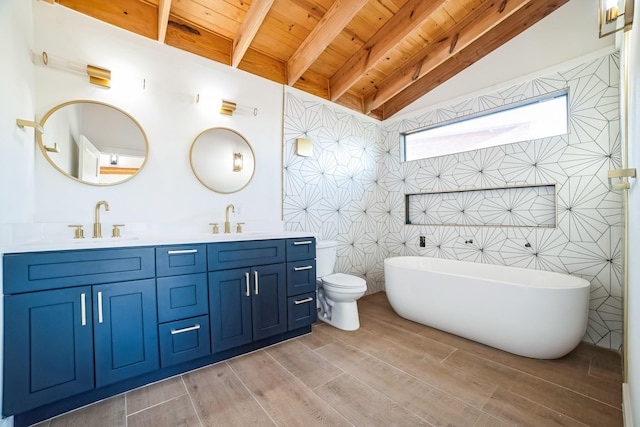 bathroom featuring vanity, vaulted ceiling with beams, a bathtub, toilet, and wooden ceiling