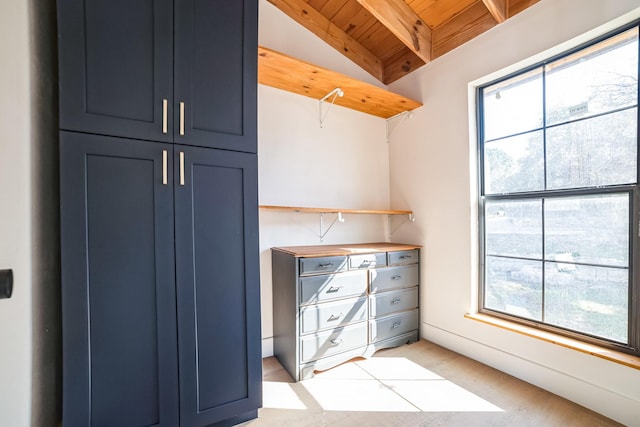 interior space featuring wooden ceiling and lofted ceiling with beams