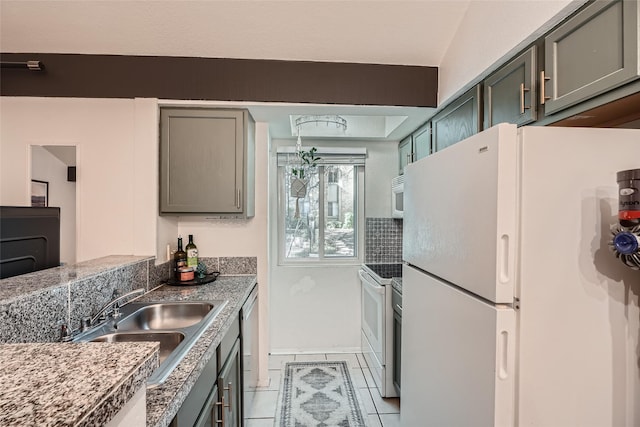 kitchen featuring sink, white appliances, and light tile patterned floors