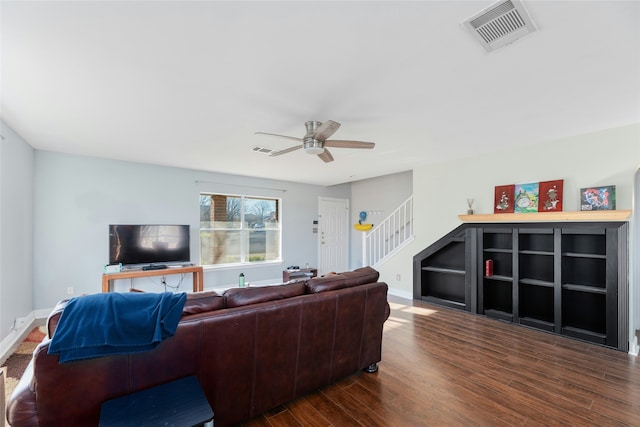 living room with ceiling fan and dark hardwood / wood-style floors