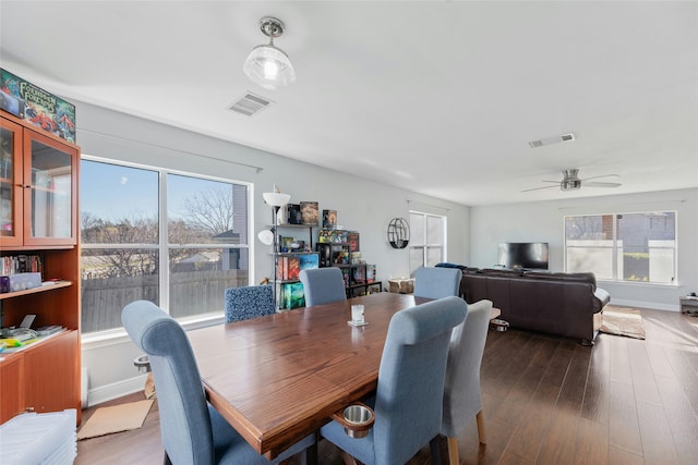 dining area with ceiling fan and hardwood / wood-style floors