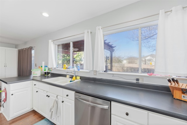 kitchen with sink, white cabinets, dishwasher, and light hardwood / wood-style flooring